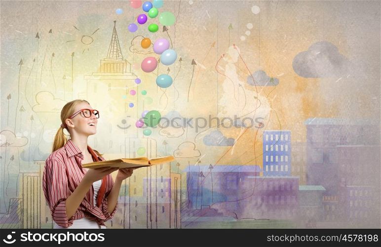 I like reading. Young funny girl with opened book in hands