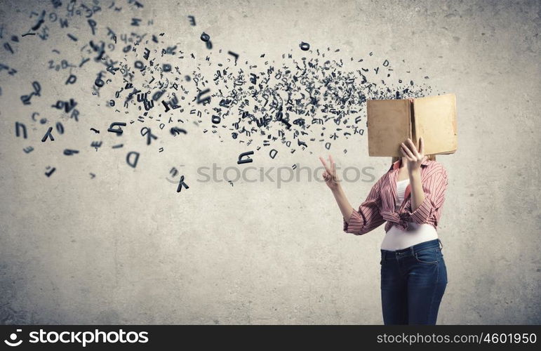 I like reading. Young funny girl with opened book in hands