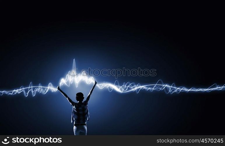 I love music. Back view of young girl in casual against dark background
