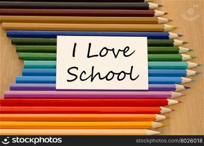 I love school text concept and colored pencil on wooden background