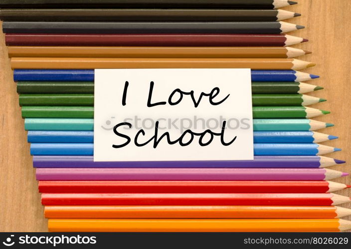 I love school text concept and colored pencil on wooden background