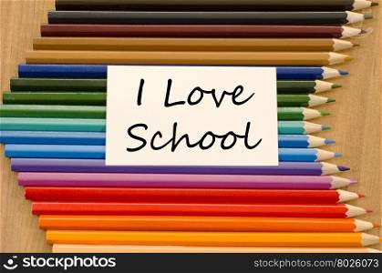 I love school text concept and colored pencil on wooden background