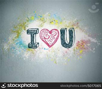 I Love You. Handwritten message on a concrete wall with an illustrated heart used as a symbol of love in this Valentines message. Graffiti bright splatter on background