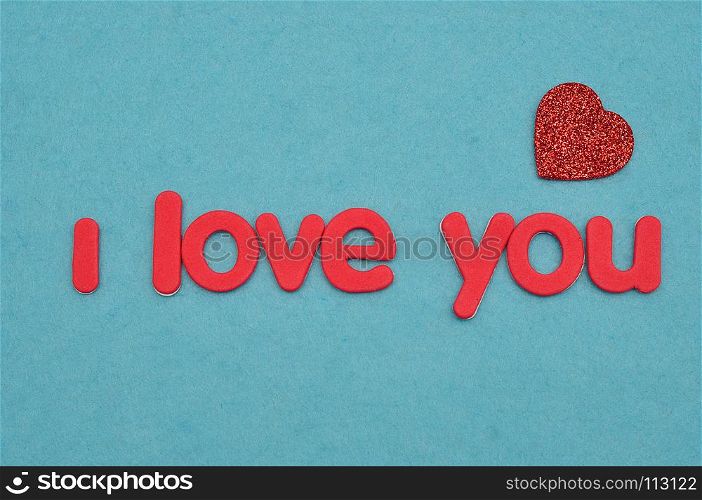 I love you in red letters on a blue background with a red heart