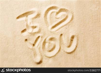 I love you message written in golden sand