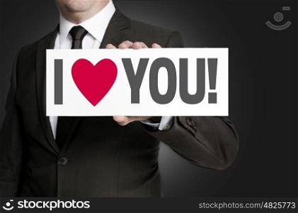 i love you sign held by businessman. i love you sign held by businessman.