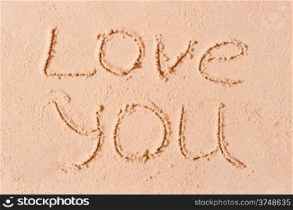 I love you written on wet sand on the beach