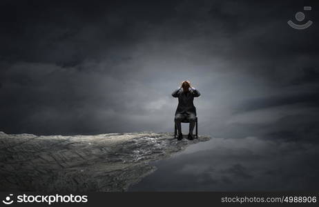 I need a break!. Young troubled businessman with hands on his head