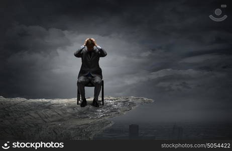 I need a break!. Young troubled businessman with hands on his head