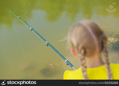 I&rsquo;ll catch big fish!. Portrait of cute girl sitting at bank and fishing