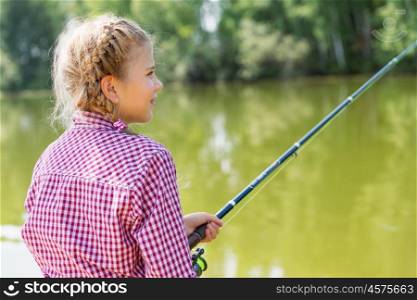I&rsquo;ll catch big fish!. Rear view of cute girl sitting at bank and fishing