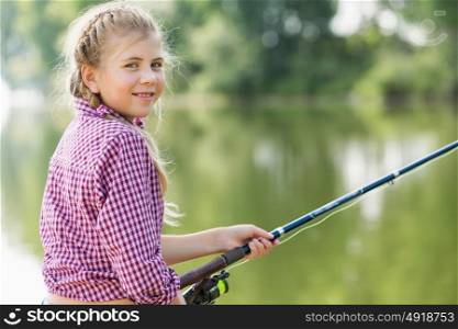 I&rsquo;ll catch big fish!. Rear view of cute girl sitting at bank and fishing