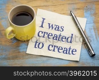 I was created to create positive affirmation note - - handwriting on a napkin with a cup of espresso coffee