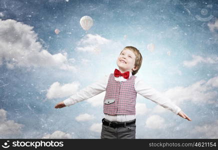 I wil become pilot. Happy kid boy with hands spread imagine he is flying