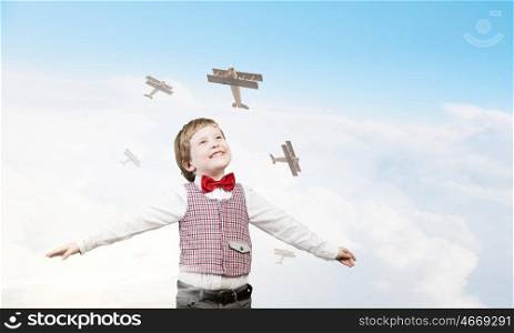I wil become pilot. Happy kid boy with hands spread imagine he is flying