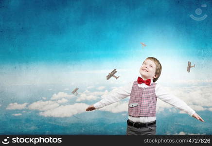 I wil become pilot. Happy kid boy with hands spread imagine he is flying