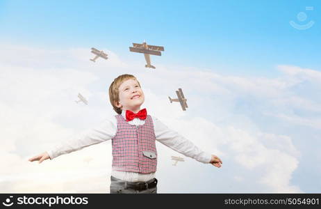 I wil become pilot. Happy kid boy with hands spread imagine he is flying