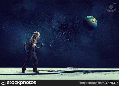 I will explore space. Cute kid boy with carton helmet on head dreaming to become astronaut. Elements of this image are furnished by NASA