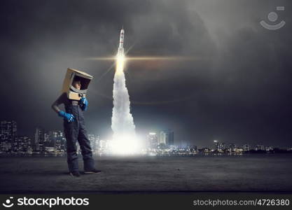 I will explore space. Cute kid boy with carton helmet on head dreaming to become astronaut