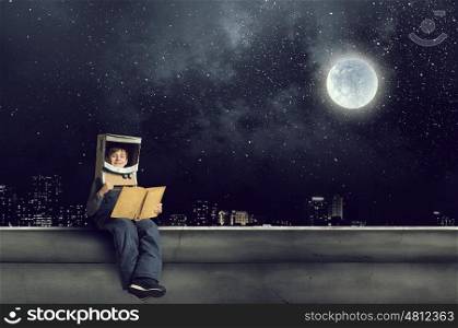 I will explore space. Cute kid boy with carton helmet on head dreaming to become astronaut