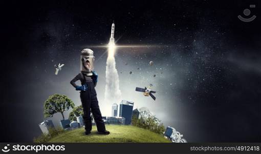 I will explore space. Cute kid boy with carton helmet on head dreaming to become astronaut