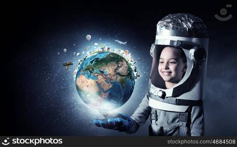 I will explore space. Cute kid girl with carton helmet on head dreaming to become astronaut. Elements of this image are furnished by NASA
