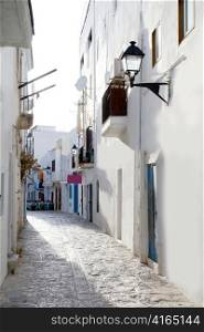 Ibiza downtown white houses narrow street in Mediterranean Spain