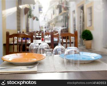 Ibiza island restaurant table with prepared dish plates and glasses
