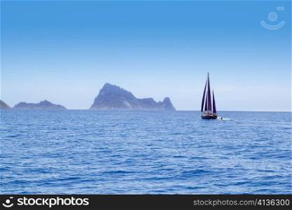 Ibiza Red sails sailboat in Es Vedra at blue mediterranean sea of Balearic