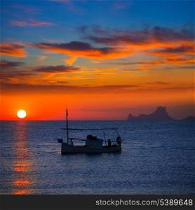 Ibiza sunset Es Vedra view and menorquina fisherboat from Formentera orange sky