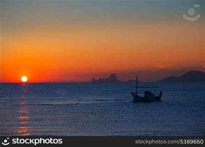 Ibiza sunset Es Vedra view and menorquina fisherboat from Formentera orange sky