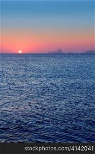 Ibiza sunset from Formentera with Es Vedra mountain in Mediterranean sea