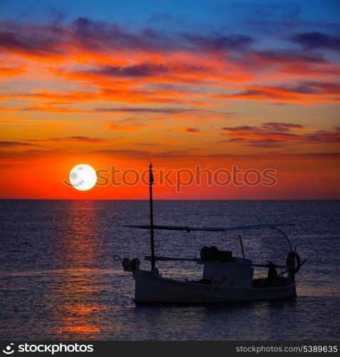 Ibiza sunset view and menorquina fisherboat from Formentera orange sky