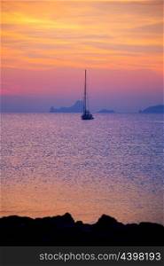 Ibiza sunset view from formentera Island with sailboat in Balearic Islands