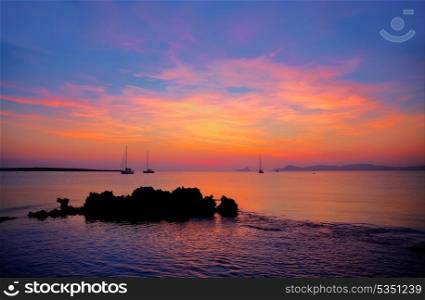 Ibiza sunset view from formentera Island with sailboat in Balearic Islands