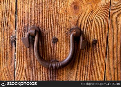 Ibiza traditional rusted iron door handle on weathered wood