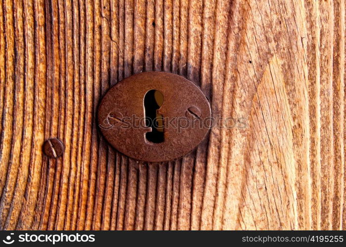 Ibiza traditional rusted iron key hole on weathered wood