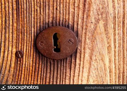 Ibiza traditional rusted iron key hole on weathered wood