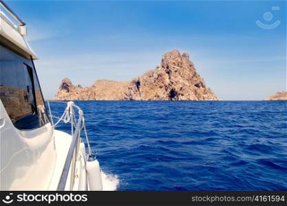 Ibiza yacht reaching Es Vedra island in Mediterranean blue sea