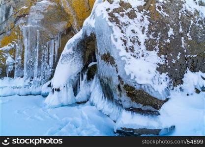 Ice and icicles on rocks at Lake Baikal, Russia