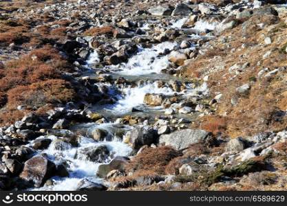 Ice and water of mountain river in Nepal