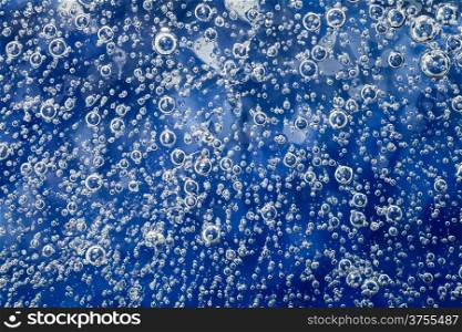 Ice background with bubbles. Natural blue texture of ice