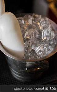 Ice bucket with ice cubes. Ice bucket filled with ice cubes closeup