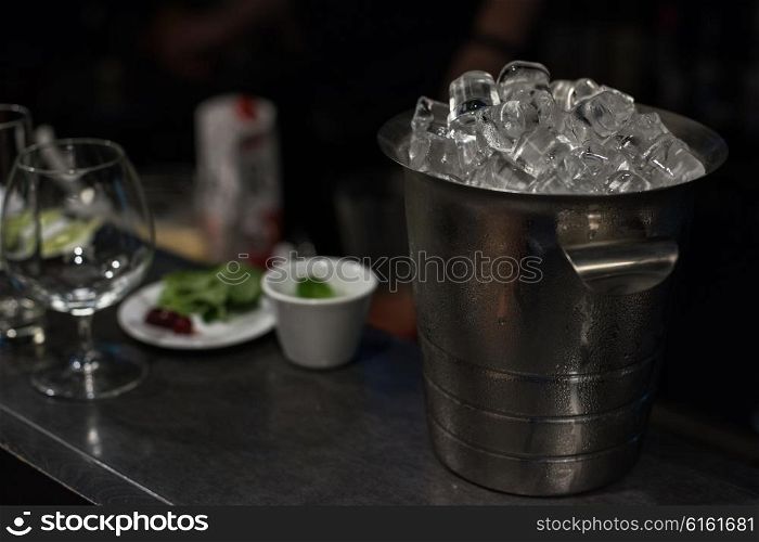 Ice bucket with ice cubes. Ice bucket filled with ice cubes closeup