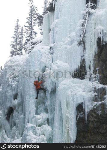 Ice climber on frozen waterfall, Johnston Canyon, Banff National Park, Alberta, Canada