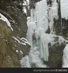 Ice climber on frozen waterfall, Johnston Canyon, Banff National Park, Alberta, Canada