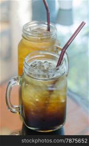 ice coffee. A glass of black iced coffee with drinking Straw