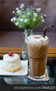 Ice coffee and young coconut cake with fresh cream and red grape. sweet dessert