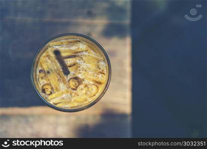 ice coffee glass on wooden table in the cafe