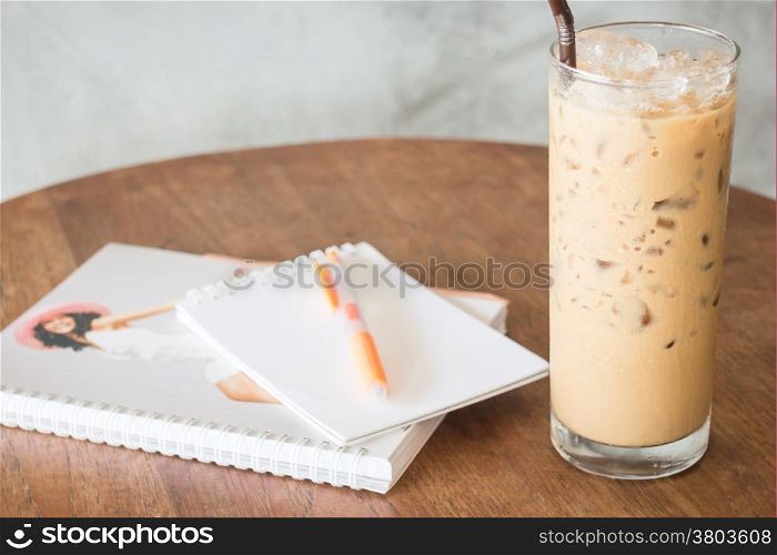 Ice coffee glass on wooden work table, stock photo